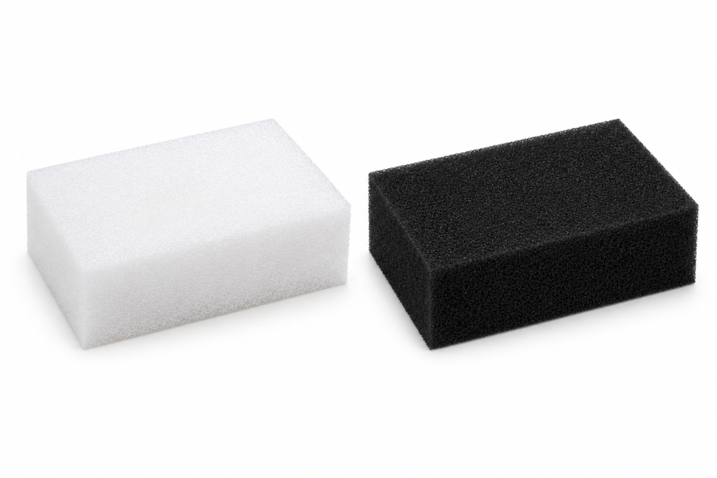 Two rectangular foam blocks, white and black, placed on a white surface and side by side.