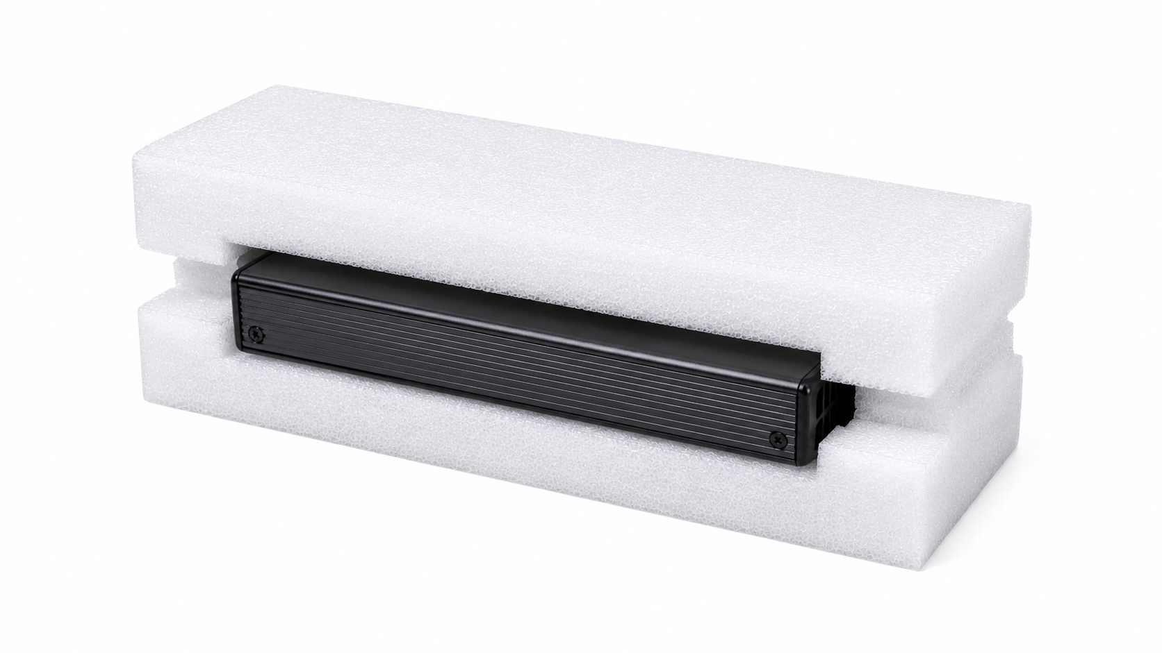 Black rectangular electronic module nestled in white foam packaging, photographed at an angle for protection during shipping.
